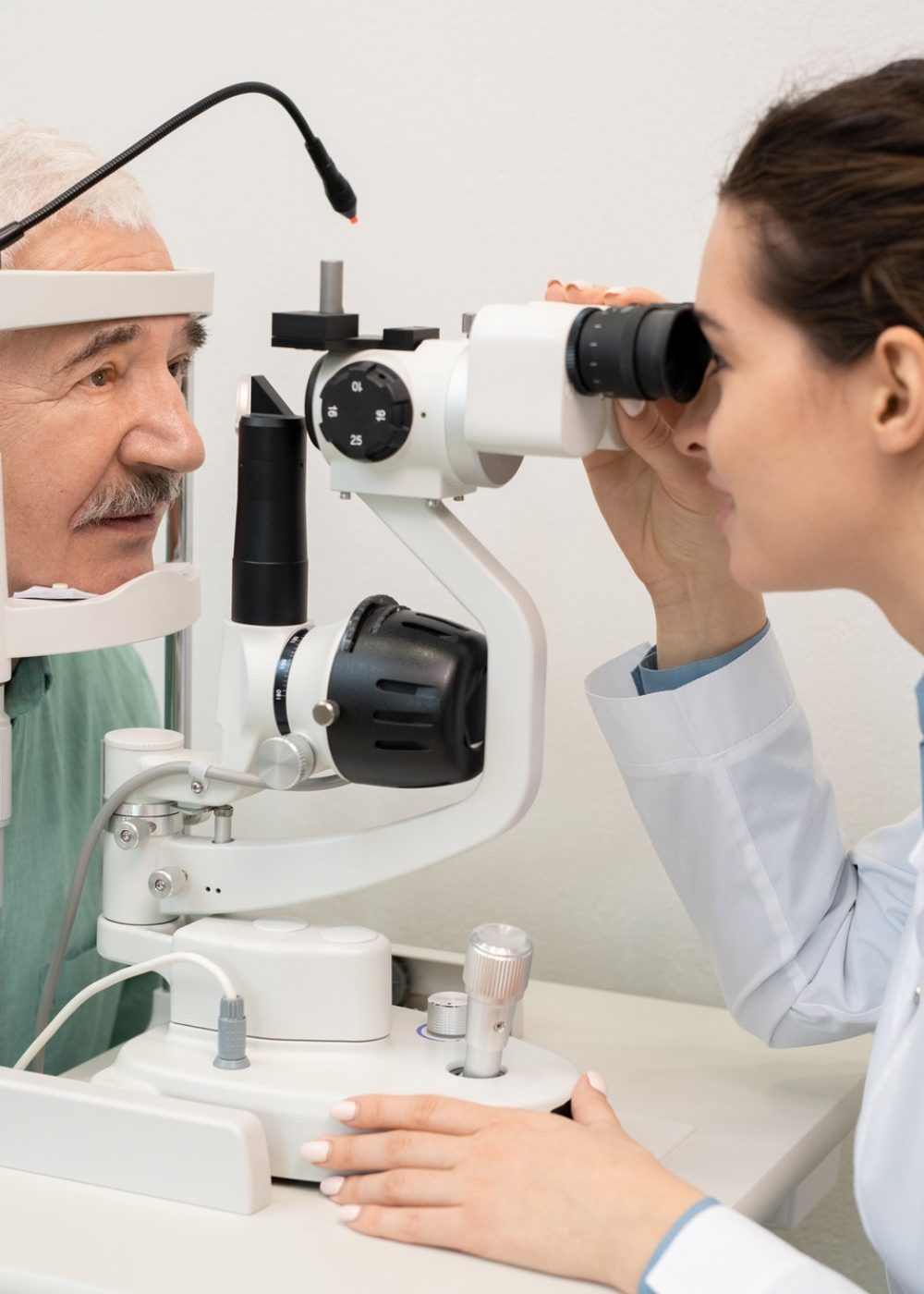 young-brunette-female-ophthalmologist-testing-eyesight-of-senior-male-patient.jpg